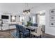Open concept dining area with a gray table, and blue chairs, overlooking living room at 47 Rosedale Way, Pittsboro, NC 27312