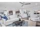 Open concept living area with white sofas, a wooden coffee table, and a ceiling fan at 47 Rosedale Way, Pittsboro, NC 27312