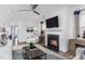 Living room featuring a fireplace, hardwood floors, and ample natural light at 47 Rosedale Way, Pittsboro, NC 27312