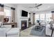 Living room with fireplace, hardwood floors, and a comfy seating arrangement at 47 Rosedale Way, Pittsboro, NC 27312