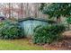 Green storage shed nestled in the backyard at 5205 Rembert Dr, Raleigh, NC 27612