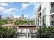 Private balcony with city view and small table with chairs at 523 S West St # 402, Raleigh, NC 27601