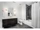 Clean bathroom with dark vanity and shower/tub combo at 523 S West St # 402, Raleigh, NC 27601