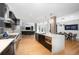 Modern kitchen with dark cabinets, quartz countertops, and island at 523 S West St # 402, Raleigh, NC 27601