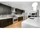 Modern kitchen with dark cabinetry, herringbone backsplash, and island at 523 S West St # 402, Raleigh, NC 27601
