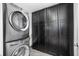 Laundry room with stackable washer and dryer and additional storage at 523 S West St # 402, Raleigh, NC 27601