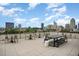 Rooftop deck with city views, modern patio furniture, and tables at 523 S West St # 402, Raleigh, NC 27601