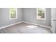 Spacious bedroom with hardwood floors and two windows at 722 Martin St, Durham, NC 27704