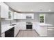 Modern kitchen with white cabinets and stainless steel appliances at 722 Martin St, Durham, NC 27704