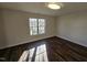 Bright bedroom with hardwood floors and large window at 104 Annotto Bay Ln, Garner, NC 27529