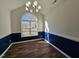 Bright dining room with hardwood floors, an arched window and blue wainscoting at 104 Annotto Bay Ln, Garner, NC 27529