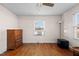 Bedroom with hardwood floors, window A/C unit and dresser at 1261 N Nc 49, Burlington, NC 27217