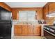 Functional kitchen with wood cabinets and modern appliances at 1261 N Nc 49, Burlington, NC 27217