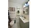 Modern bathroom with gray vanity and floating shelves at 138 Dorsey Pl, Henderson, NC 27536