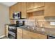 Modern kitchen with stainless steel appliances and granite countertops at 1516 Pearces Rd, Zebulon, NC 27597