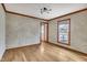 Bright living room with hardwood floors and large window at 1516 Pearces Rd, Zebulon, NC 27597