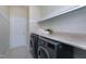 Convenient laundry room with washer, dryer, and ample storage at 209 Bog Hill Ln, Cary, NC 27519