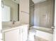 Clean bathroom with a bathtub and grey tile at 2407 Hart St # A, Durham, NC 27703