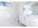 Bright bathroom featuring white cabinets and a large mirror at 2407 Hart St # A, Durham, NC 27703