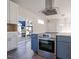 Modern kitchen with stainless steel appliances and white cabinets at 2407 Hart St # A, Durham, NC 27703
