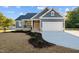 Gray house with white trim, brown door, and landscaping at 2722 Maple Ave, Burlington, NC 27215