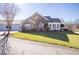 Stone and siding house with sunroom and 2 car garage at 413 Faith Dr, Gibsonville, NC 27249