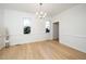 Spacious dining room with hardwood floors and chandelier at 4601 Eastbrae Ct, Fuquay Varina, NC 27526