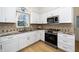 Modern kitchen with granite countertops and white cabinets at 4601 Eastbrae Ct, Fuquay Varina, NC 27526