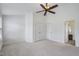 Bright bedroom featuring a ceiling fan, carpet, and access to a bathroom at 6018 Viking Dr, Raleigh, NC 27612