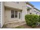 Back patio with adjacent storage and green shrubbery at 6018 Viking Dr, Raleigh, NC 27612