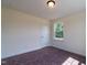 Well-lit bedroom featuring carpet, a window, and a closet at 6100 Sunset Lake Road Rd, Fuquay Varina, NC 27526