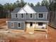 Two-story house with gray siding and white accents; new construction with deck and porch at 80 Purslane Dr, Franklinton, NC 27525