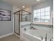 Spa-like bathroom with soaking tub and walk-in shower at 817 Heartpine Dr, Mebane, NC 27302