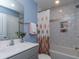 Clean bathroom with a shower/tub combo and modern vanity at 817 Heartpine Dr, Mebane, NC 27302