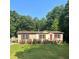 Single-story home with red accents and a spacious yard at 7055 Old Plantation Dr, Graham, NC 27253