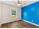 Bedroom with hardwood floors, blue accent wall, and ceiling fan at 205 Esteban Ct, Mebane, NC 27302