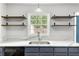 Modern kitchen with gray cabinets, quartz countertops, and stainless steel appliances at 205 Esteban Ct, Mebane, NC 27302