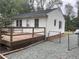 White house with deck and gravel driveway at 1737 Hedge St, Burlington, NC 27217