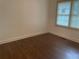Well-lit bedroom, showcasing hardwood floors and a window at 1737 Hedge St, Burlington, NC 27217