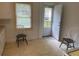 Kitchen with door to backyard, wood flooring and white cabinets at 1737 Hedge St, Burlington, NC 27217