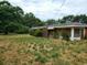 Brick ranch house with overgrown yard at 899 Pittman Ln, Micro, NC 27555