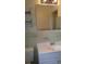 Bathroom with light green tiled walls and a white vanity at 1133 Evans Rd, Cary, NC 27513