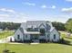 Modern farmhouse with metal roof and stone accents at 8917 Grand Highland Way, Wake Forest, NC 27587