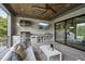 Outdoor kitchen and lounge area with built-in grill, bar seating, and comfortable sofa at 8917 Grand Highland Way, Wake Forest, NC 27587