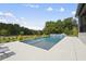 Relaxing pool area with tiled deck and lush greenery at 8917 Grand Highland Way, Wake Forest, NC 27587