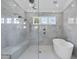 Modern bathroom with a walk-in shower, built-in seat, and a freestanding bathtub at 8917 Grand Highland Way, Wake Forest, NC 27587