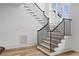 Open staircase with light wood and black railing at 8917 Grand Highland Way, Wake Forest, NC 27587