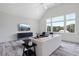 Spacious living room with vaulted ceiling, large windows, and scenic view at 8917 Grand Highland Way, Wake Forest, NC 27587