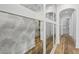 Long hallway with mirrored wall and hardwood floors at 8917 Grand Highland Way, Wake Forest, NC 27587