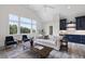 Relaxing living area with a wet bar, comfortable seating, and wooded views at 8917 Grand Highland Way, Wake Forest, NC 27587